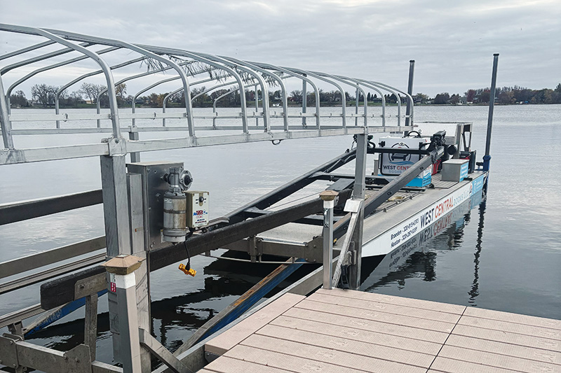 Boat lift with canopy frame beside aluminum dock in West Central Minnesota.