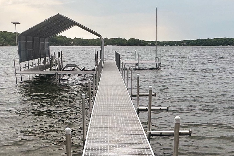 Aluminum dock with covered boat lift on a lake in West Central Minnesota.