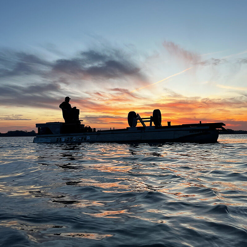 West Central Docks service barge on lake at sunset in West Central Minnesota.